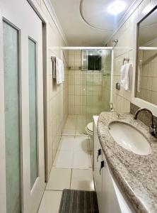 a bathroom with a sink and a shower at João Machado Fortes in Florianópolis