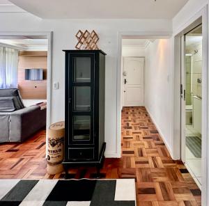 a living room with a black cabinet and a couch at João Machado Fortes in Florianópolis