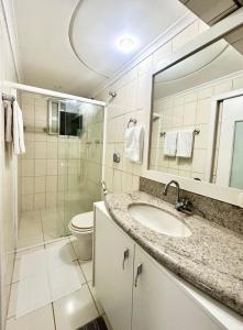 a bathroom with a sink and a shower and a toilet at João Machado Fortes in Florianópolis