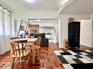 a kitchen and living room with a table and chairs at João Machado Fortes in Florianópolis +15 photos
