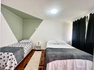 a bedroom with two beds and a window at João Machado Fortes in Florianópolis
