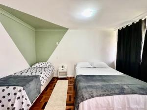 a bedroom with two beds and a window at João Machado Fortes in Florianópolis