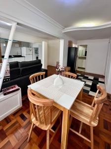 a kitchen and living room with a table and chairs at João Machado Fortes in Florianópolis
