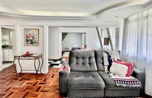 a living room with a couch and a table at João Machado Fortes in Florianópolis