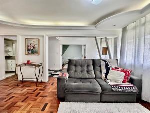 a living room with a couch and a table at João Machado Fortes in Florianópolis