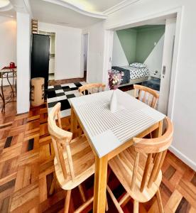a dining room and living room with a table and chairs at João Machado Fortes in Florianópolis