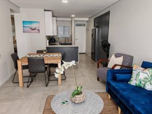 a living room with a blue couch and a table at Bellamare Royal in Summerstrand