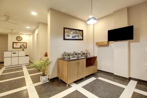 a lobby with a bar with a flat screen tv at Limewood Stay - Corporate Huda City Centre in Gurgaon