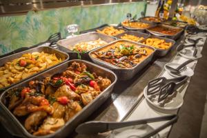 a buffet with many trays of different types of food at Oasis Lanz Beach Mate in Costa Teguise