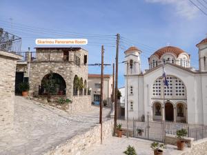 a church and a building with a street at Skarinou Panorama Room in Skarinou