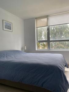 Giường trong phòng chung tại Espectacular departamento en Algarrobo