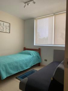 Giường trong phòng chung tại Espectacular departamento en Algarrobo