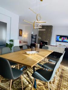 a dining room with a wooden table and chairs at Morfeas Apartment Ioannina in Anatolí +19 photos