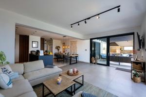 a living room with a white couch and a living room at Villa Blue Horizon in Seget Vranjica