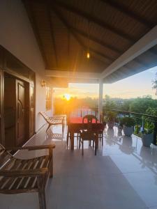 a patio with a table and chairs on a balcony at Massimo Hotel Weligama in Weligama