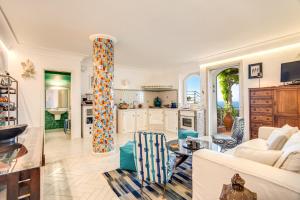a living room with a couch and a table at POSEA Collection - Villa Ponente in Positano