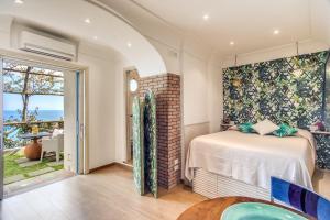 a bedroom with a bed and a large window at POSEA Collection - Villa Ponente in Positano +80 photos