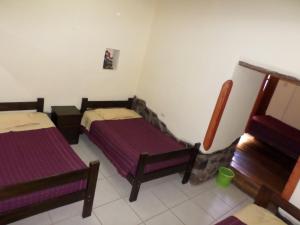 a room with two beds in a room at OkiDoki Cusco Hostal in Cusco