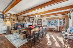 a dining room with a table and chairs and a fireplace at Cottage Inn The Woods -- Pond, Pet Friendly, Grill, Wifi, Fire Pit, Deck, Screen Porch, Fireplace, Private in Berkeley Springs