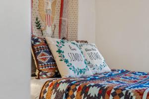 a bed with two pillows on top of it at Cottage Inn The Woods -- Pond, Pet Friendly, Grill, Wifi, Fire Pit, Deck, Screen Porch, Fireplace, Private in Berkeley Springs +55 photos