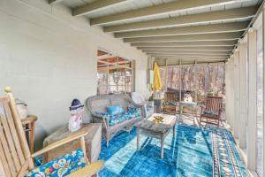 a living room with chairs and a table at Cottage Inn The Woods -- Pond, Pet Friendly, Grill, Wifi, Fire Pit, Deck, Screen Porch, Fireplace, Private in Berkeley Springs