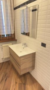 a bathroom with a sink and a mirror at Residenza FULLINI Polcenigo in Polcenigo +37 photos