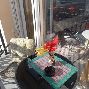 a table with a vase of flowers on a table at Apartman Prodan in Sombor
