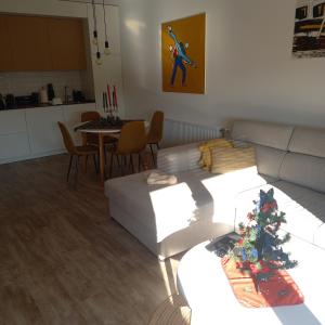 a living room with a couch and a christmas tree at Apartman Prodan in Sombor