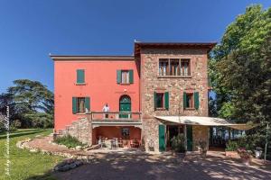 a man standing on the balcony of a house at Locanda Donna Laura in Imola