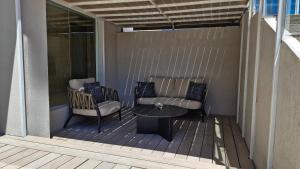 a patio with a couch and a table on a deck at Amérian Córdoba Park Hotel in Córdoba