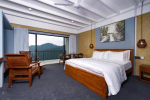 a bedroom with a large bed and a balcony at Kelvin Eco Resort in Dedugala +41 photos