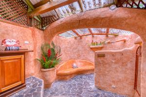 a bathroom with a tub and a toilet in a room at Tree House Beachfront Lodge in Puerto Viejo +37 photos