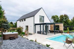 a white house with a swimming pool and a patio at Villa Estelle - pool, jacuzzi, sauna - Balaton in Balatonkenese