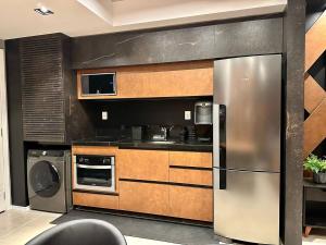Kuchyň nebo kuchyňský kout v ubytování Lindo Loft próximo ao Iguatemi