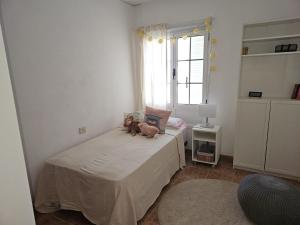 a bedroom with two teddy bears sitting on a bed at Casa Gabriela in Arrieta