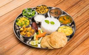 a plate of food with different types of food on a table at Park Inn by Radisson Ayodhya in Ayodhya