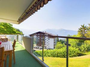 a balcony with a table and a view at Magnifique appartement avec vue sur les sommets enneigés in Crans-Montana