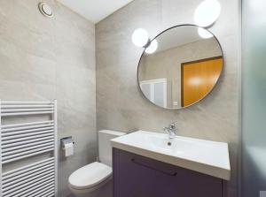 a bathroom with a sink and a mirror at Magnifique appartement avec vue sur les sommets enneigés in Crans-Montana