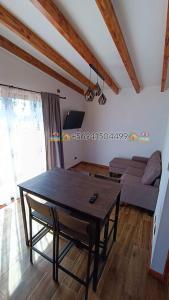 a living room with a table and a couch at Cabaña Playa Rosada in Valdivia