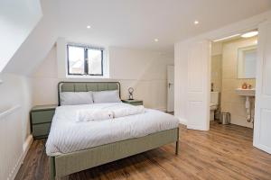a bedroom with a large bed with a window at Uxbridge Home 1 bed flat in Uxbridge +17 photos