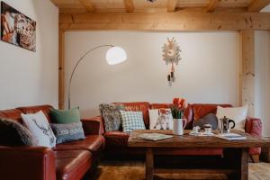 a living room with a couch and a table at Luxuriöse Schwarzwald Loft Heustock mit Sauna und Whirlpool am Griesbachhof in Titisee-Neustadt +27 photos