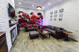 a living room with a couch and a wall with flowers at Apartament 7 Chernivtsi in Chernivtsi