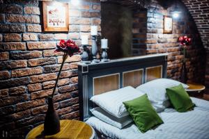 a bedroom with a bed and a brick wall at Apartament 7 Chernivtsi in Chernivtsi