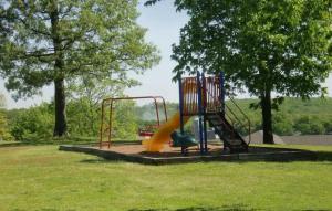 a playground with a slide in a park at Spacious 3 BR Ozark Penthouse in Four Seasons