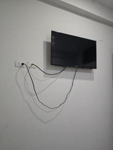 a flat screen tv hanging on a wall at Hospedaje Mas in Tarapoto +43 photos