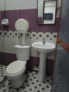 a bathroom with a toilet and a sink at Hospedaje Mas in Tarapoto