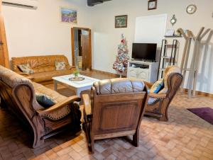 a living room with furniture and a christmas tree at La Ferme Des Pierrettes in Menneville
