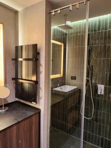 a bathroom with a glass shower and a sink at Woodside Mount Kopaonik in Kopaonik