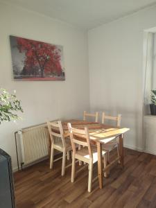 a dining room table with chairs and a painting on the wall at Kzwei in Ruppertshofen +2 photos