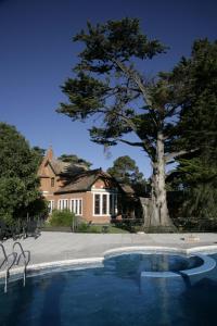 a house with a tree and a swimming pool at Hotel Boutique Villa Art in La Cumbre